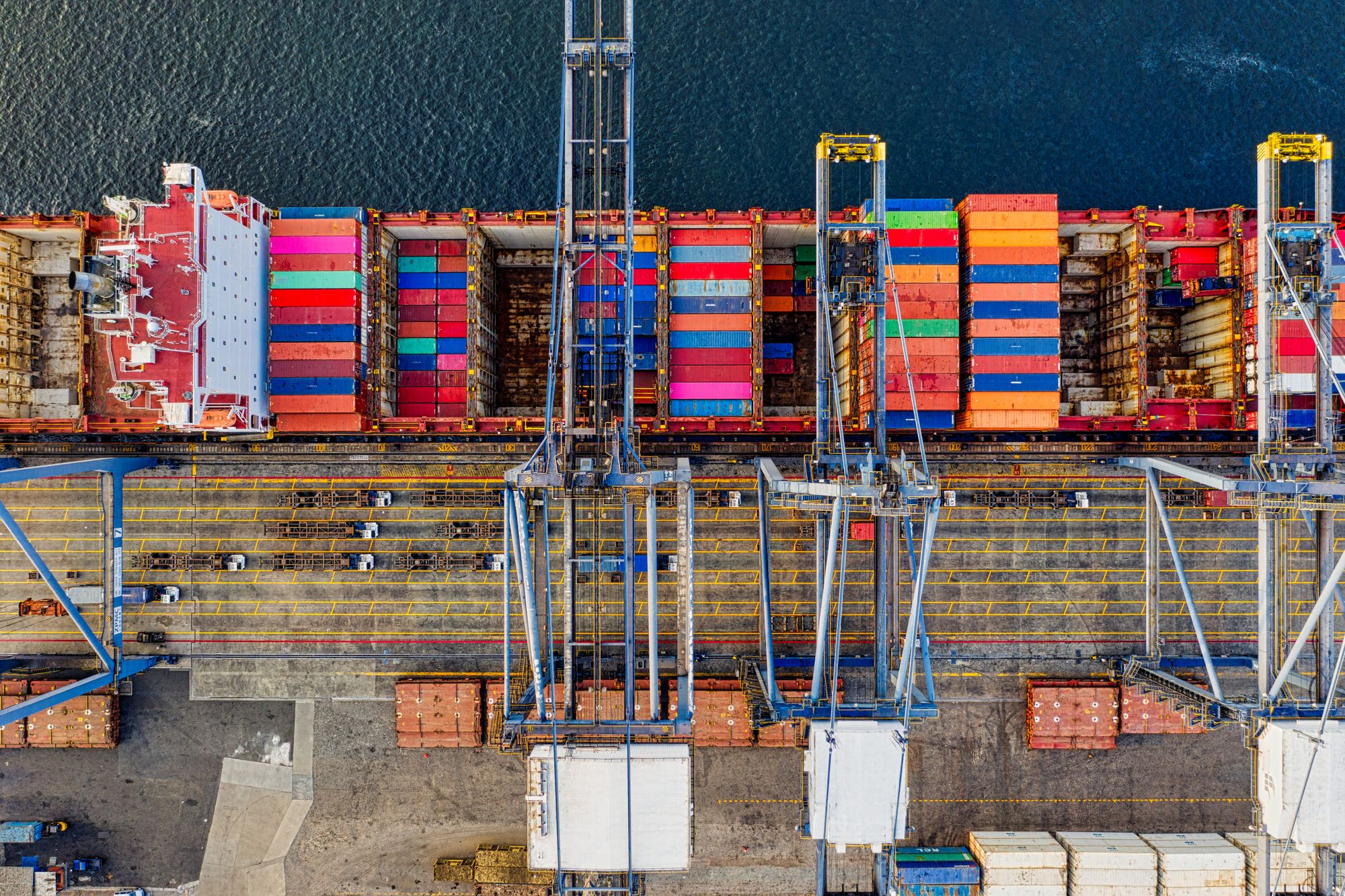 Aerial view of a container ship and port cranes